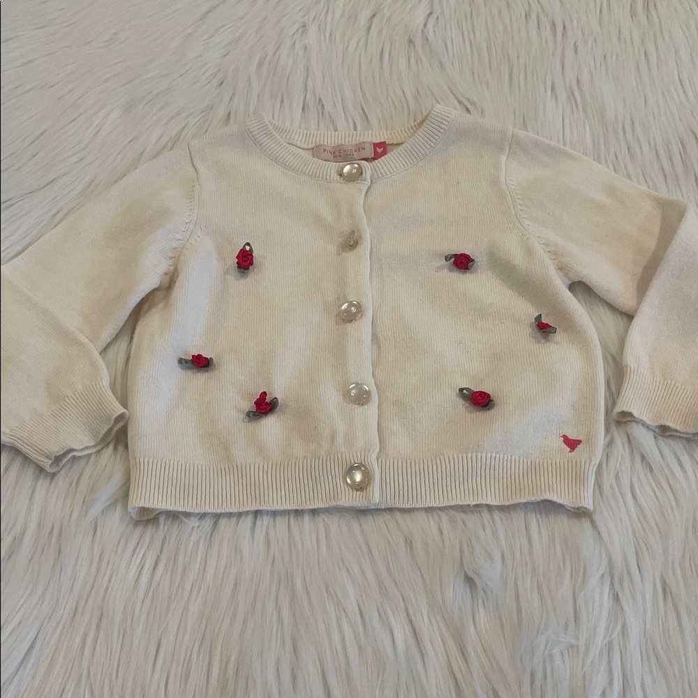 Pink Chicken Toddler Girl’s Cream Cardigan with Red Rosettes